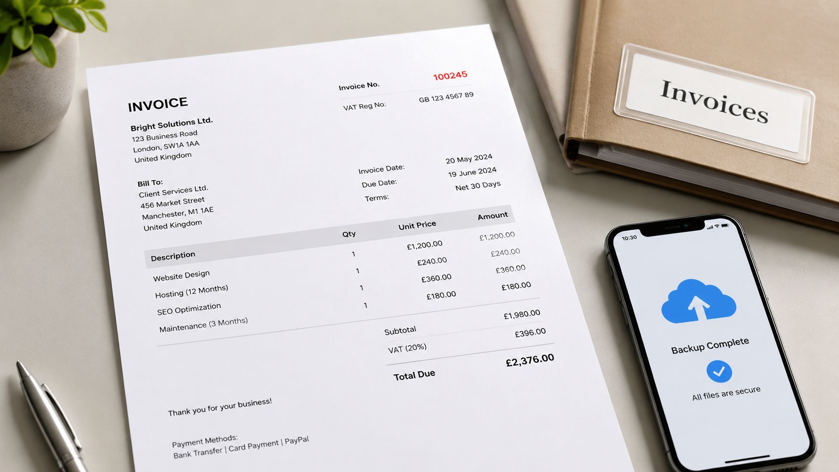 A professional invoice document from Bright Solutions Ltd lies on a desk next to a mobile phone.