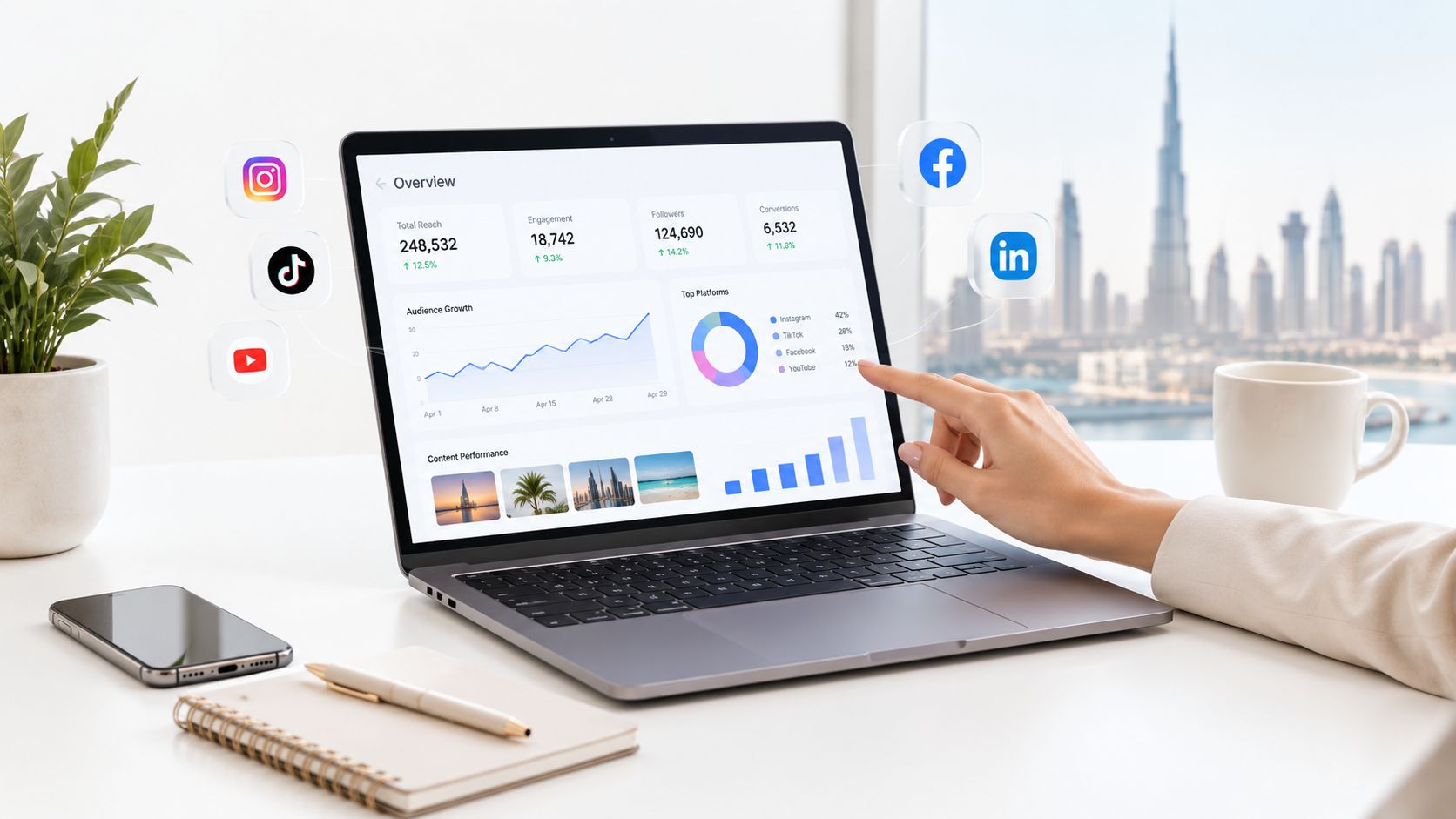 A person using a laptop to analyse digital marketing performance metrics with the Dubai skyline in the background.