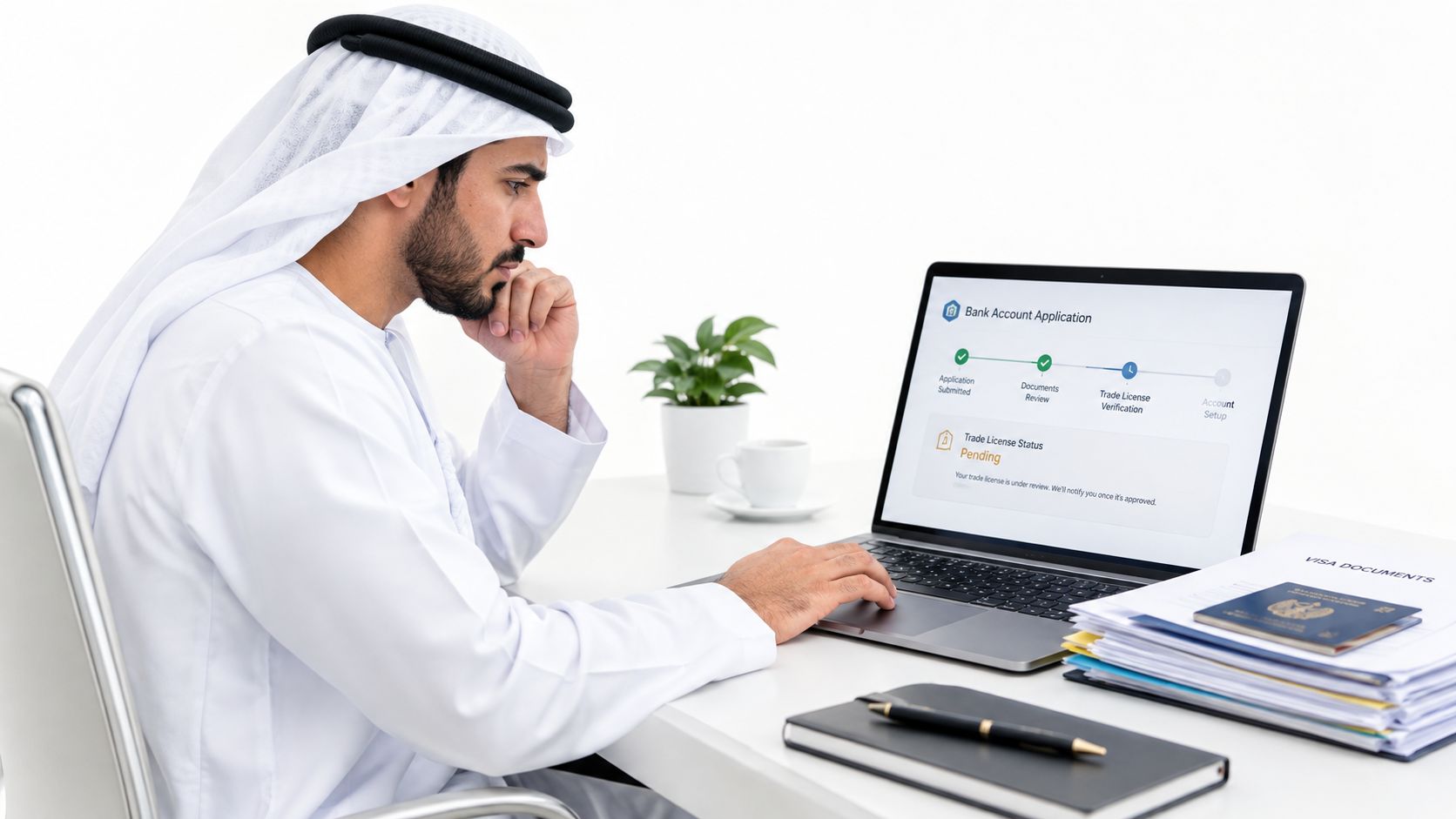 A professional man in traditional attire checking his trade license status on a laptop at a desk.